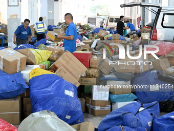 Workers are sorting parcels at an express logistics company in Taicang, China, on June 18, 2024. (