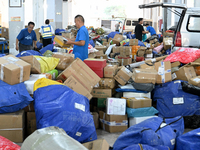 Workers are sorting parcels at an express logistics company in Taicang, China, on June 18, 2024. (