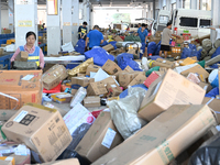 Workers are sorting parcels at an express logistics company in Taicang, China, on June 18, 2024. (