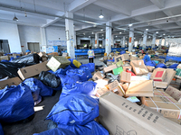 Workers are sorting parcels at an express logistics company in Taicang, China, on June 18, 2024. (