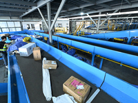 An automated sorting line is delivering express goods at an express logistics company in Taicang, China, on June 18, 2024. (