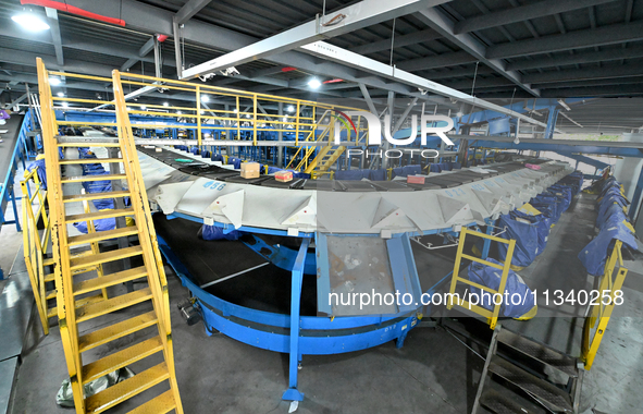 An automated sorting line is delivering express goods at an express logistics company in Taicang, China, on June 18, 2024. 