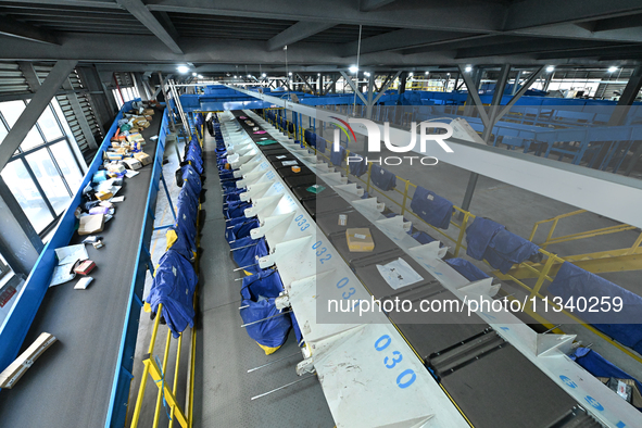 An automated sorting line is delivering express goods at an express logistics company in Taicang, China, on June 18, 2024. 