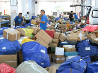 Workers are sorting parcels at an express logistics company in Taicang, China, on June 18, 2024. (