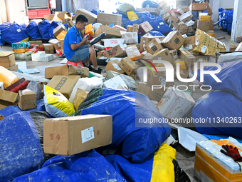 Workers are sorting parcels at an express logistics company in Taicang, China, on June 18, 2024. (