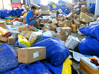 Workers are sorting parcels at an express logistics company in Taicang, China, on June 18, 2024. (