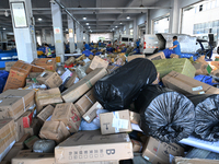 Workers are sorting parcels at an express logistics company in Taicang, China, on June 18, 2024. (