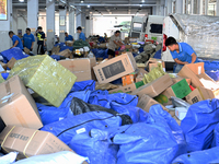 Workers are sorting parcels at an express logistics company in Taicang, China, on June 18, 2024. (