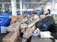 Workers are sorting parcels at an express logistics company in Taicang, China, on June 18, 2024. (