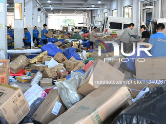 Workers are sorting parcels at an express logistics company in Taicang, China, on June 18, 2024. (