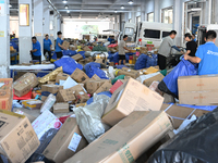 Workers are sorting parcels at an express logistics company in Taicang, China, on June 18, 2024. (