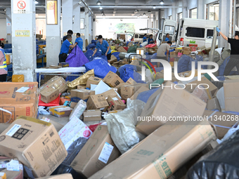 Workers are sorting parcels at an express logistics company in Taicang, China, on June 18, 2024. (