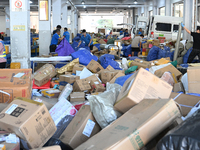 Workers are sorting parcels at an express logistics company in Taicang, China, on June 18, 2024. (