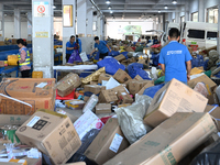 Workers are sorting parcels at an express logistics company in Taicang, China, on June 18, 2024. (