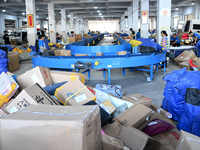 Workers are sorting parcels at an express logistics company in Taicang, China, on June 18, 2024. (