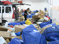 Workers are sorting parcels at an express logistics company in Taicang, China, on June 18, 2024. (