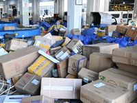 Workers are sorting parcels at an express logistics company in Taicang, China, on June 18, 2024. (