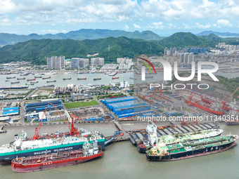 Workers are repairing a ship under the hot sun at the Zhoushan Wanbang Yongyue Ship Repair Co., LTD in Putuo district of Zhoushan City, Zhej...