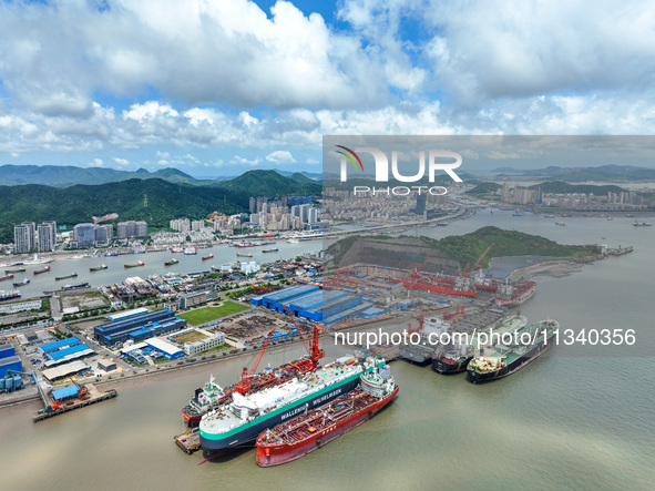 Workers are repairing a ship under the hot sun at the Zhoushan Wanbang Yongyue Ship Repair Co., LTD in Putuo district of Zhoushan City, Zhej...