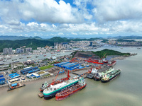 Workers are repairing a ship under the hot sun at the Zhoushan Wanbang Yongyue Ship Repair Co., LTD in Putuo district of Zhoushan City, Zhej...