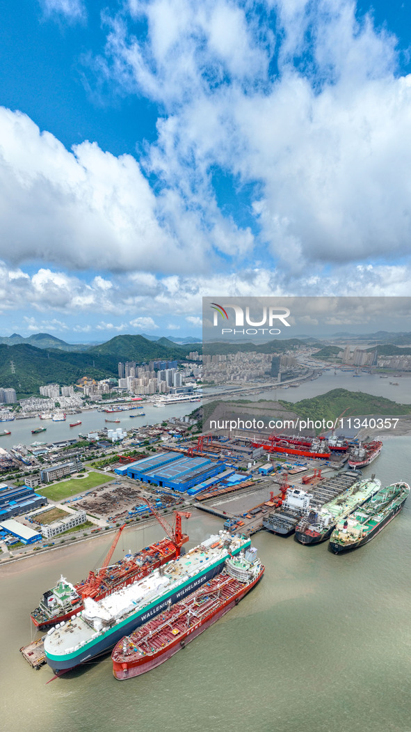 Workers are repairing a ship under the hot sun at the Zhoushan Wanbang Yongyue Ship Repair Co., LTD in Putuo district of Zhoushan City, Zhej...