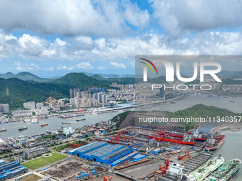 Workers are repairing a ship under the hot sun at the Zhoushan Wanbang Yongyue Ship Repair Co., LTD in Putuo district of Zhoushan City, Zhej...