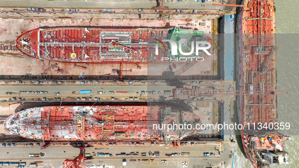 Workers are repairing a ship under the hot sun at the Zhoushan Wanbang Yongyue Ship Repair Co., LTD in Putuo district of Zhoushan City, Zhej...