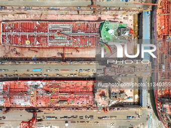 Workers are repairing a ship under the hot sun at the Zhoushan Wanbang Yongyue Ship Repair Co., LTD in Putuo district of Zhoushan City, Zhej...