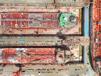 Workers are repairing a ship under the hot sun at the Zhoushan Wanbang Yongyue Ship Repair Co., LTD in Putuo district of Zhoushan City, Zhej...