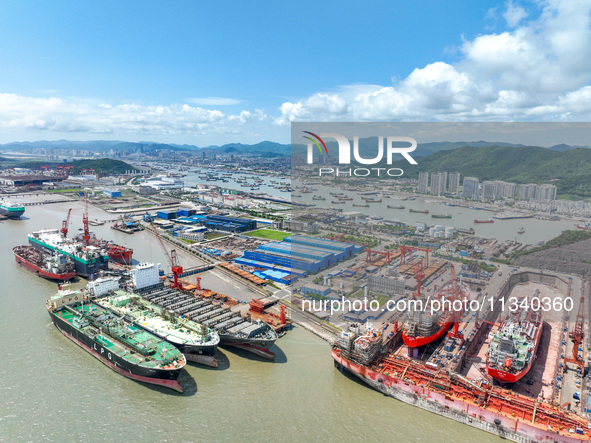 Workers are repairing a ship under the hot sun at the Zhoushan Wanbang Yongyue Ship Repair Co., LTD in Putuo district of Zhoushan City, Zhej...