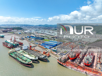 Workers are repairing a ship under the hot sun at the Zhoushan Wanbang Yongyue Ship Repair Co., LTD in Putuo district of Zhoushan City, Zhej...