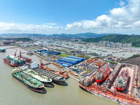 Workers are repairing a ship under the hot sun at the Zhoushan Wanbang Yongyue Ship Repair Co., LTD in Putuo district of Zhoushan City, Zhej...