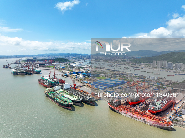 Workers are repairing a ship under the hot sun at the Zhoushan Wanbang Yongyue Ship Repair Co., LTD in Putuo district of Zhoushan City, Zhej...