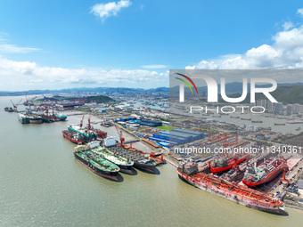 Workers are repairing a ship under the hot sun at the Zhoushan Wanbang Yongyue Ship Repair Co., LTD in Putuo district of Zhoushan City, Zhej...