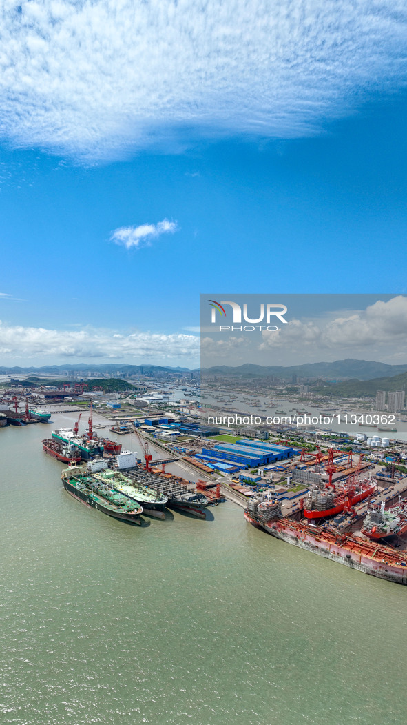 Workers are repairing a ship under the hot sun at the Zhoushan Wanbang Yongyue Ship Repair Co., LTD in Putuo district of Zhoushan City, Zhej...