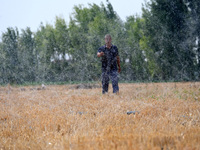 A farmer is using a ''micro-spray belt'' watering method to water a field in Daying village, Handan city, North China's Hebei province, on J...