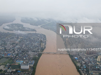 Floodwaters are passing through the Rongan county section of the Rongjiang River in the upper reaches of the Pearl River in Liuzhou, Guangxi...