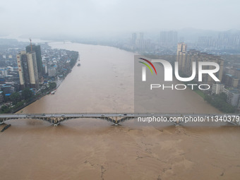 Floodwaters are passing through the Rongan county section of the Rongjiang River in the upper reaches of the Pearl River in Liuzhou, Guangxi...