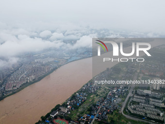 Floodwaters are passing through the Rongan county section of the Rongjiang River in the upper reaches of the Pearl River in Liuzhou, Guangxi...