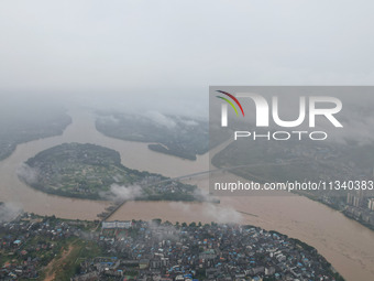 Floodwaters are passing through the Rongan county section of the Rongjiang River in the upper reaches of the Pearl River in Liuzhou, Guangxi...