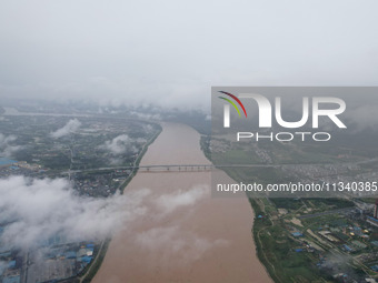 Floodwaters are passing through the Rongan county section of the Rongjiang River in the upper reaches of the Pearl River in Liuzhou, Guangxi...