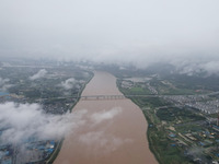 Floodwaters are passing through the Rongan county section of the Rongjiang River in the upper reaches of the Pearl River in Liuzhou, Guangxi...