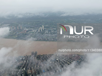 Floodwaters are passing through the Rongan county section of the Rongjiang River in the upper reaches of the Pearl River in Liuzhou, Guangxi...