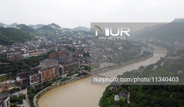 Water level is rising in the Maotai Township section of the Chishui River due to heavy rainfall in Renhuai, China, on June 18, 2024. 