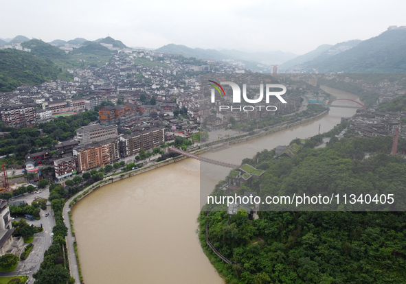 Water level is rising in the Maotai Township section of the Chishui River due to heavy rainfall in Renhuai, China, on June 18, 2024. 