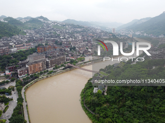 Water level is rising in the Maotai Township section of the Chishui River due to heavy rainfall in Renhuai, China, on June 18, 2024. (