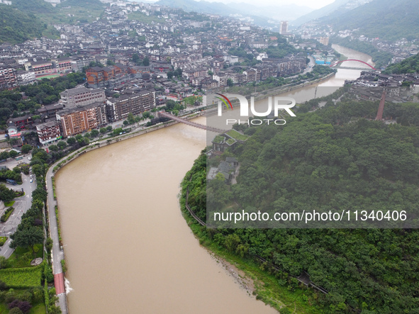 Water level is rising in the Maotai Township section of the Chishui River due to heavy rainfall in Renhuai, China, on June 18, 2024. 