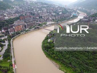 Water level is rising in the Maotai Township section of the Chishui River due to heavy rainfall in Renhuai, China, on June 18, 2024. (