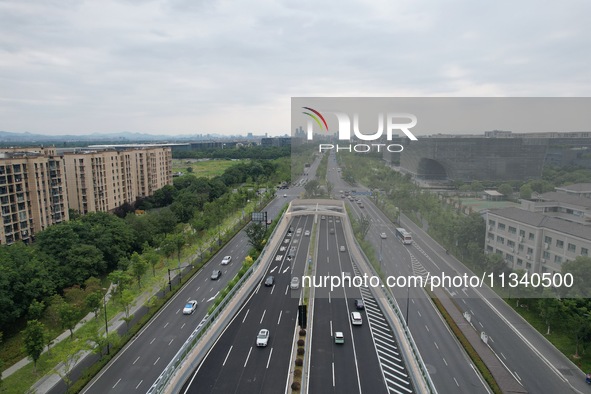 Vehicles are passing through the Wenyi West Road tunnel in Hangzhou, China, on June 18, 2024. 