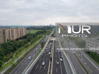 Vehicles are passing through the Wenyi West Road tunnel in Hangzhou, China, on June 18, 2024. (